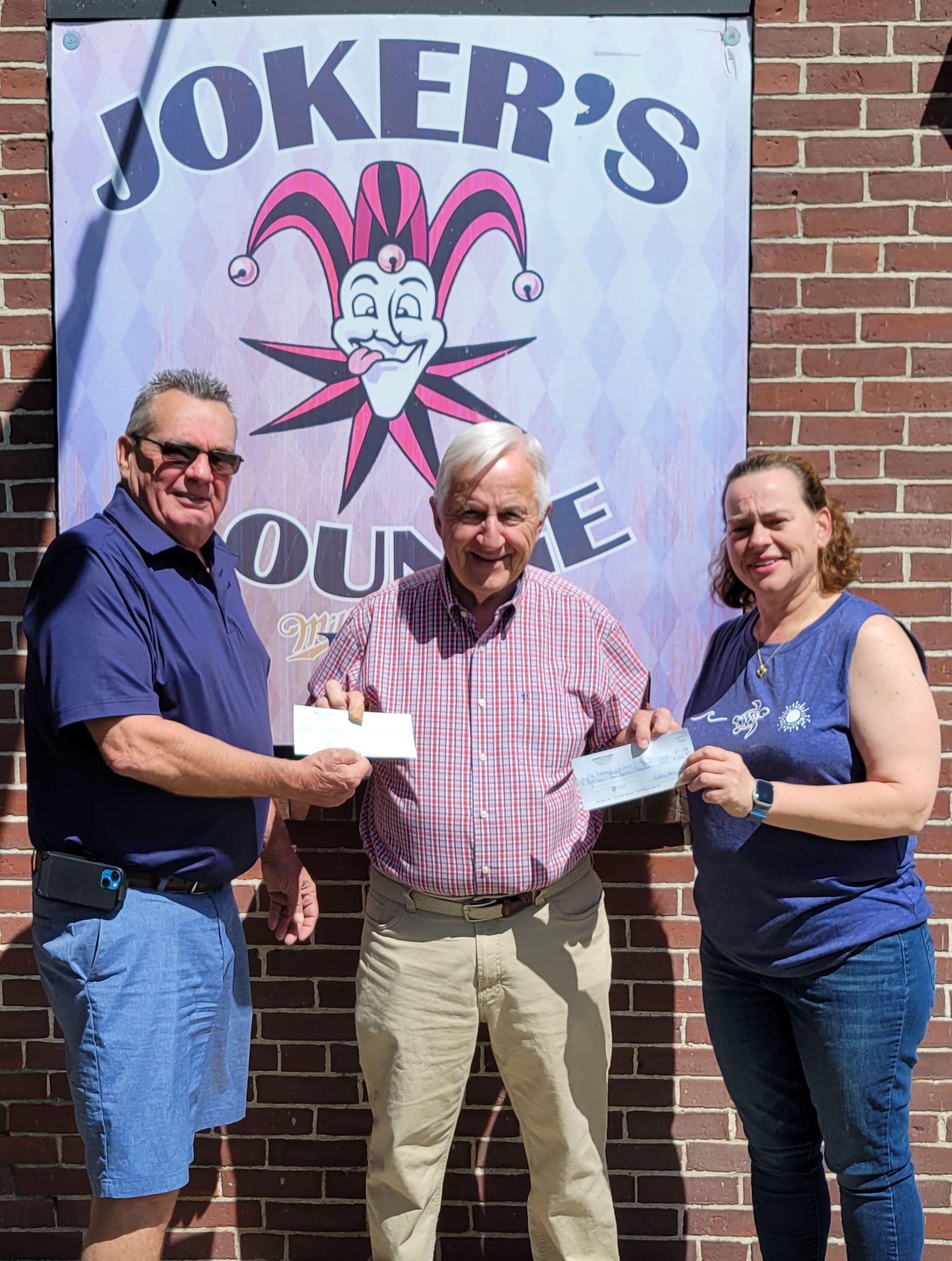 Everett Penney accepts donations from Ed Morgan and Ashley McLuin.